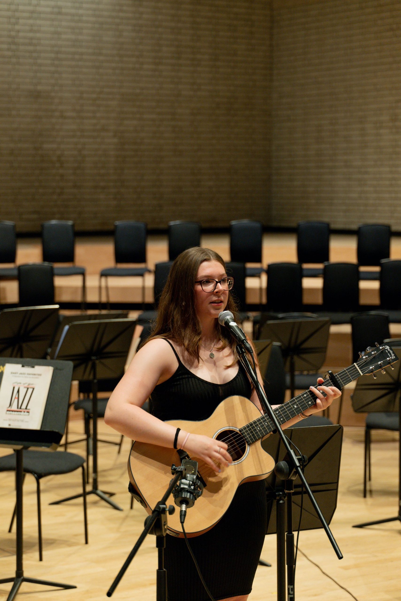 girl playing guitar and singing