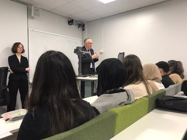 Supreme Court Justice Lord Phillips delivers a presentation to seated Loreto College students