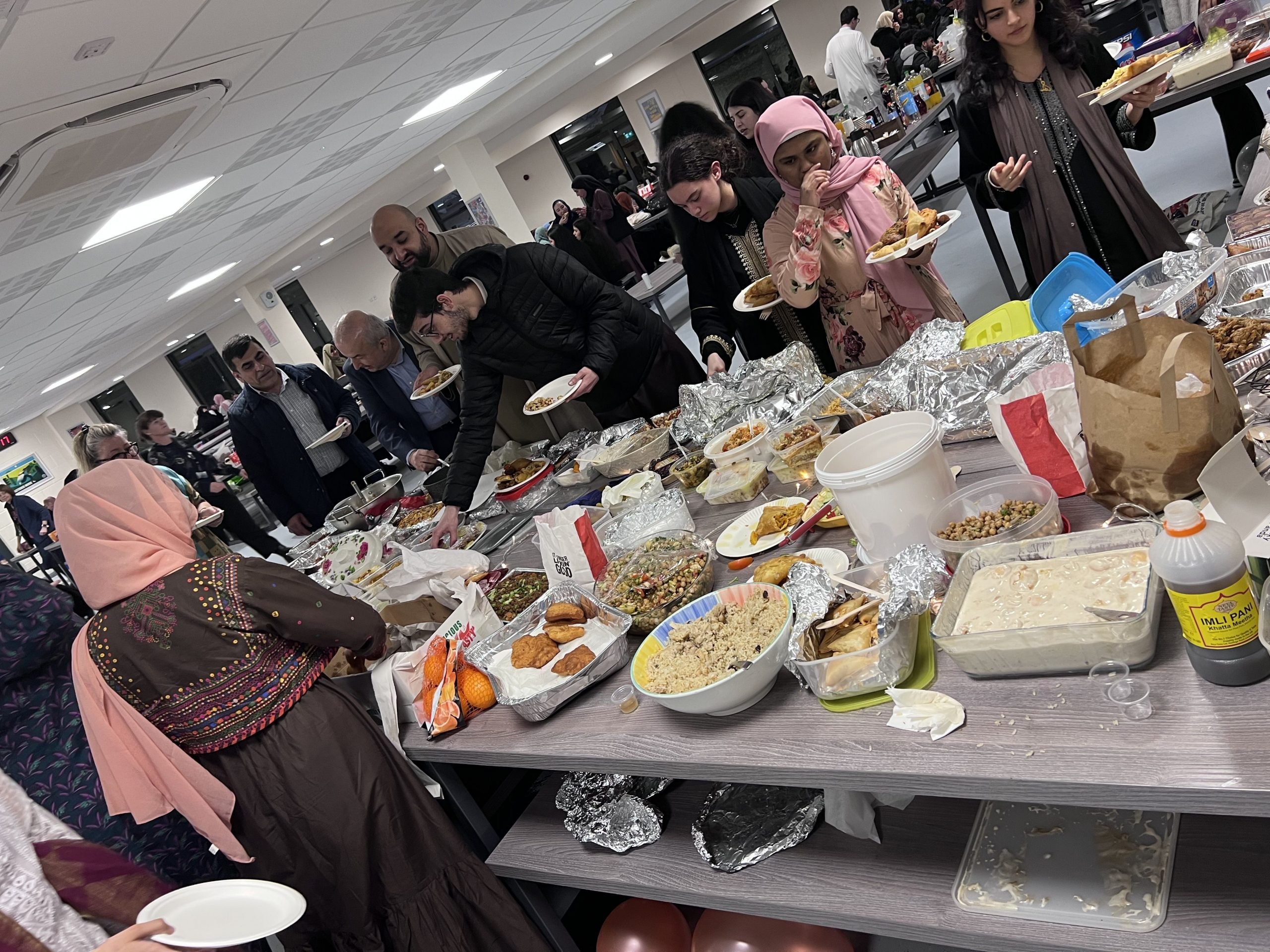A full cafeteria at Loreto with staff, students and staff enjoying Iftar together.