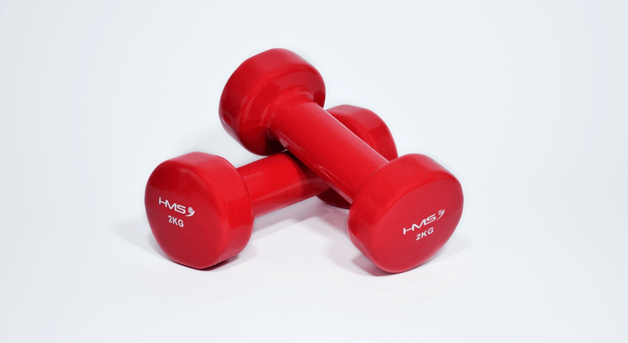 a pair of small red dumb bells