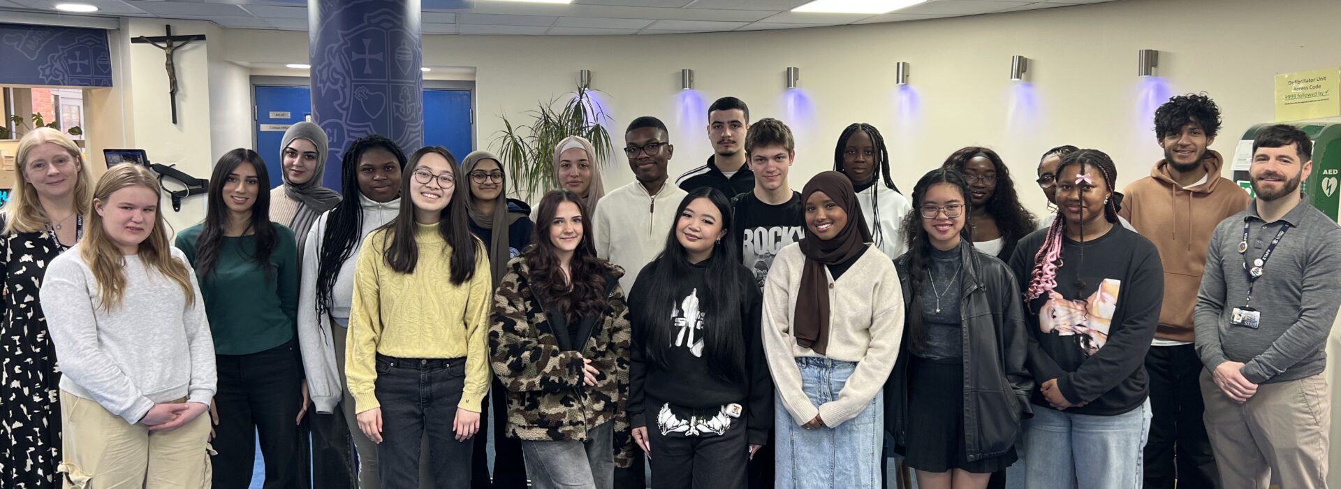 picture of a group of students and Senior Leaders to celebrate the mental health award for the college