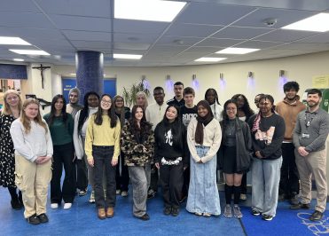 picture of a group of students and Senior Leaders to celebrate the mental health award for the college
