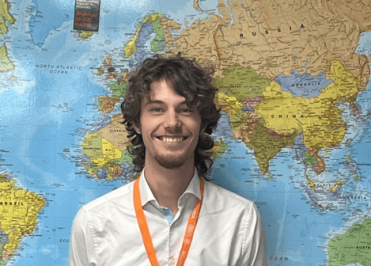 Former Loreto student Jack Wilson stood in front of a map of the world.