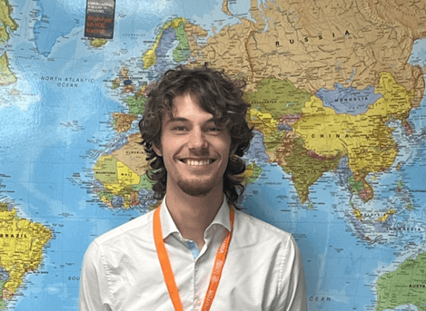 Former Loreto student Jack Wilson stood in front of a map of the world.