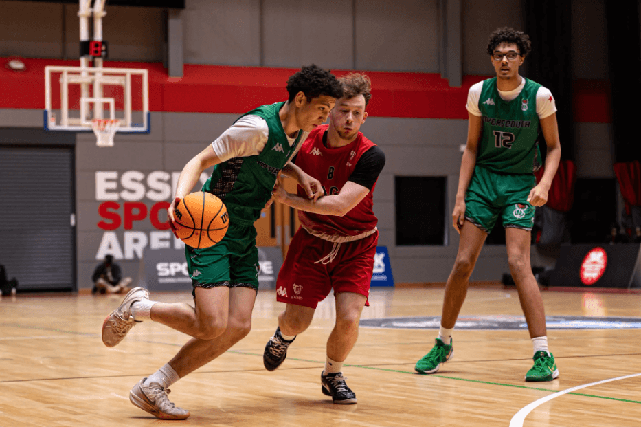 A Loreto College student, Jack of the Manchester Magic Academy, drives forward with the basketball during the Elite Academy Basketball League Final while being closely defended on court.