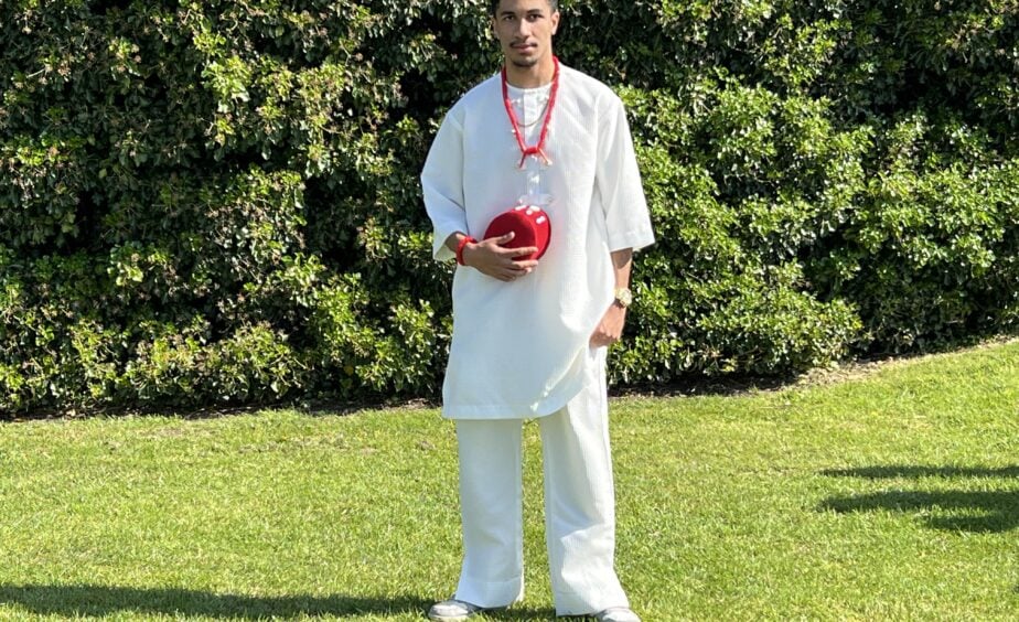 A student in traditional cultural clothing at Loreto College Manchester during Cultural Appreciation Day, standing outdoors on campus.