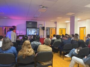 Audience members watch student films being screened during the Loreto Film Awards 2026 ceremony.