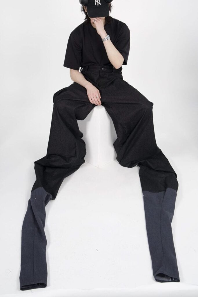 Former Loreto College student Samuel Man modelling a fashion design piece created during his creative studies, reflecting his background in fashion, textiles and design.