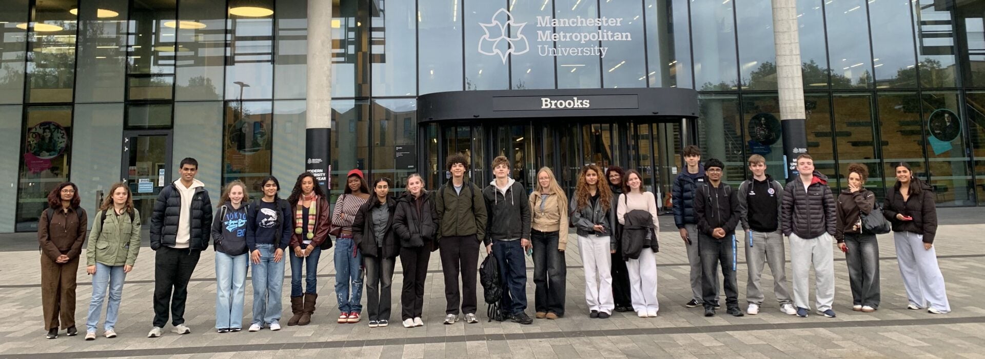 Loreto Geography students standing outside the Brooks Building at Manchester Metropolitan University before attending a wildlife lecture.
