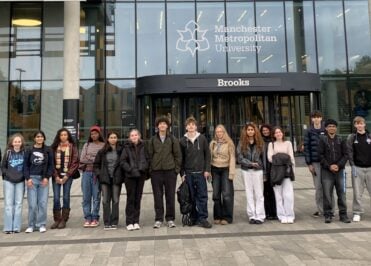 Loreto Geography students standing outside the Brooks Building at Manchester Metropolitan University before attending a wildlife lecture.