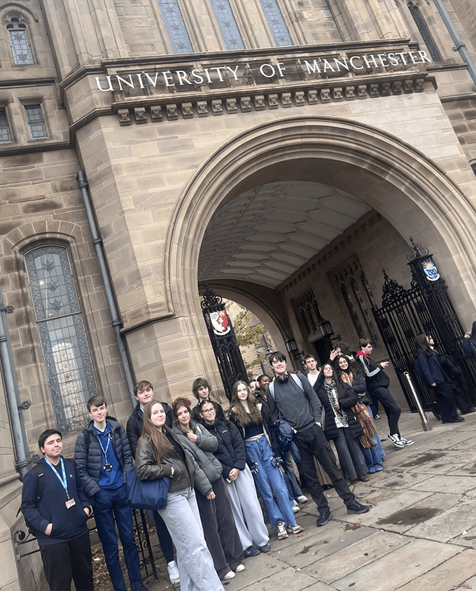 Loreto College history students gathered outside the historic entrance to the University of Manchester during an educational visit.